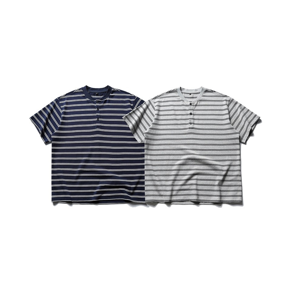 Two short-sleeve striped Henley shirts laid flat: one navy with white stripes and one gray with black stripes.