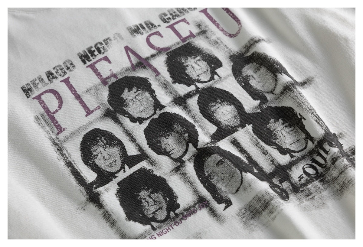 Close-up of a distressed black-and-gray portrait collage with plum lettering printed on an off-white T-shirt.