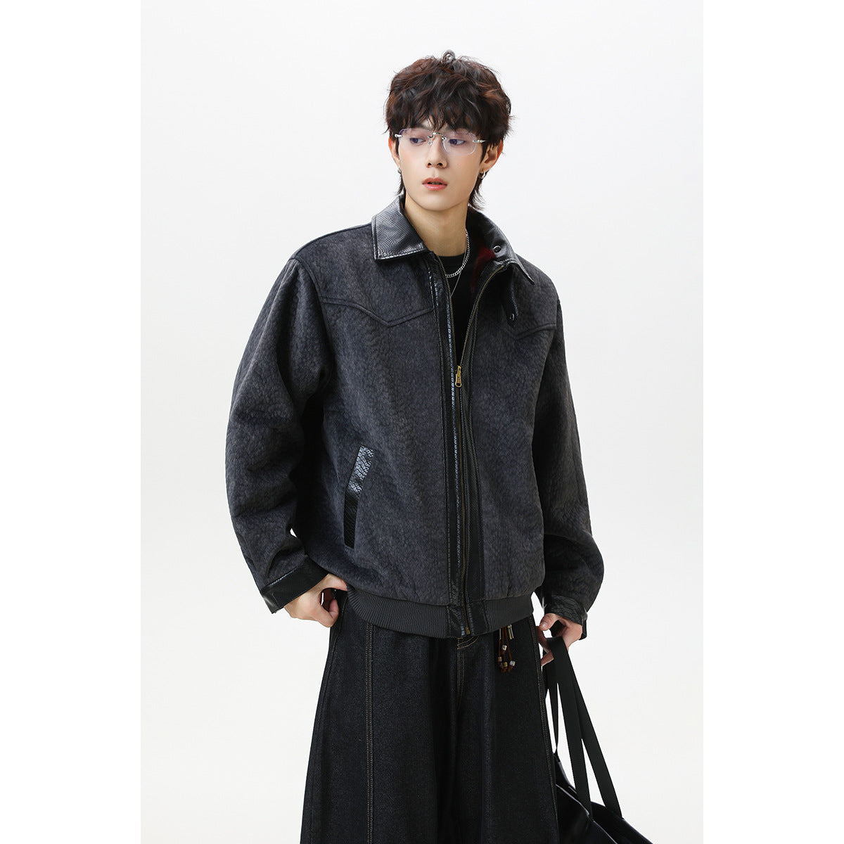 Model wearing a dark charcoal textured zip jacket with a black collar, cuffs, and ribbed hem.