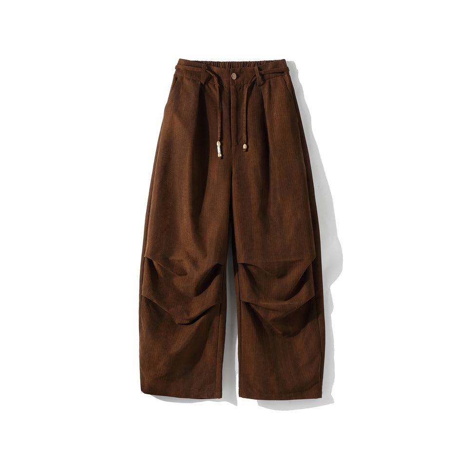 Brown wide-leg pants flat lay, front view, with drawstring, button and knee pleats