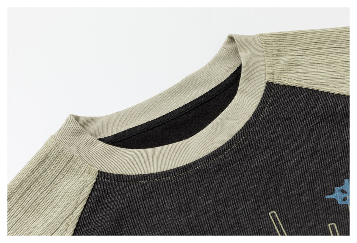 Close-up of the top's cream ribbed crew neck and sleeve seams against the charcoal body.