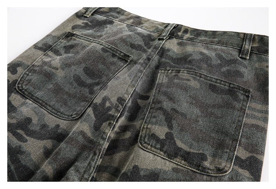 Partial rear view of dark camouflage trousers showing the waistband, belt loops, and two patch pockets.
