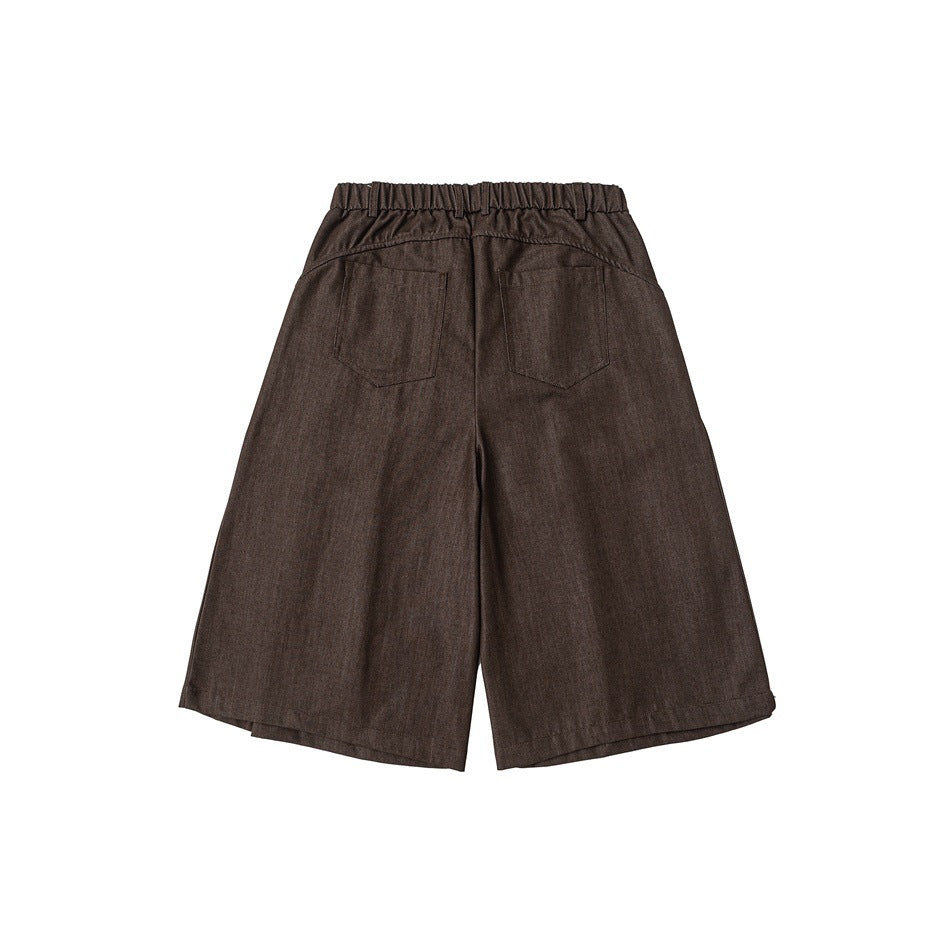 Back view of brown wide-leg shorts with a gathered waistband and two rear pockets.