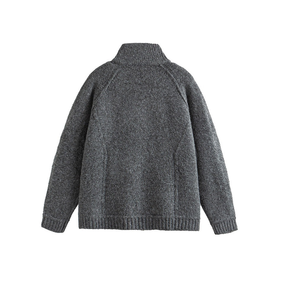 Back view of a charcoal gray high-neck knit sweater with raglan sleeves and ribbed cuffs and hem on white.