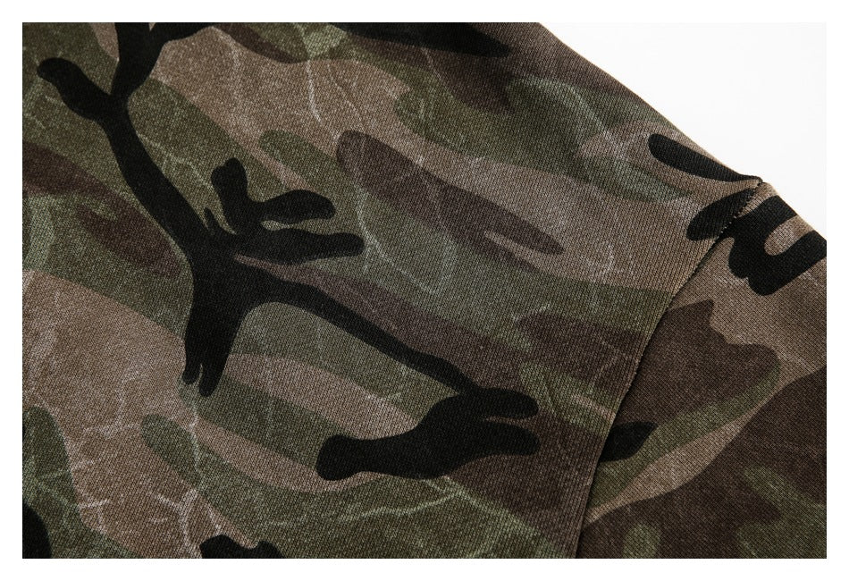 Close-up of the camouflage fabric and stitched seam on a hoodie sleeve.