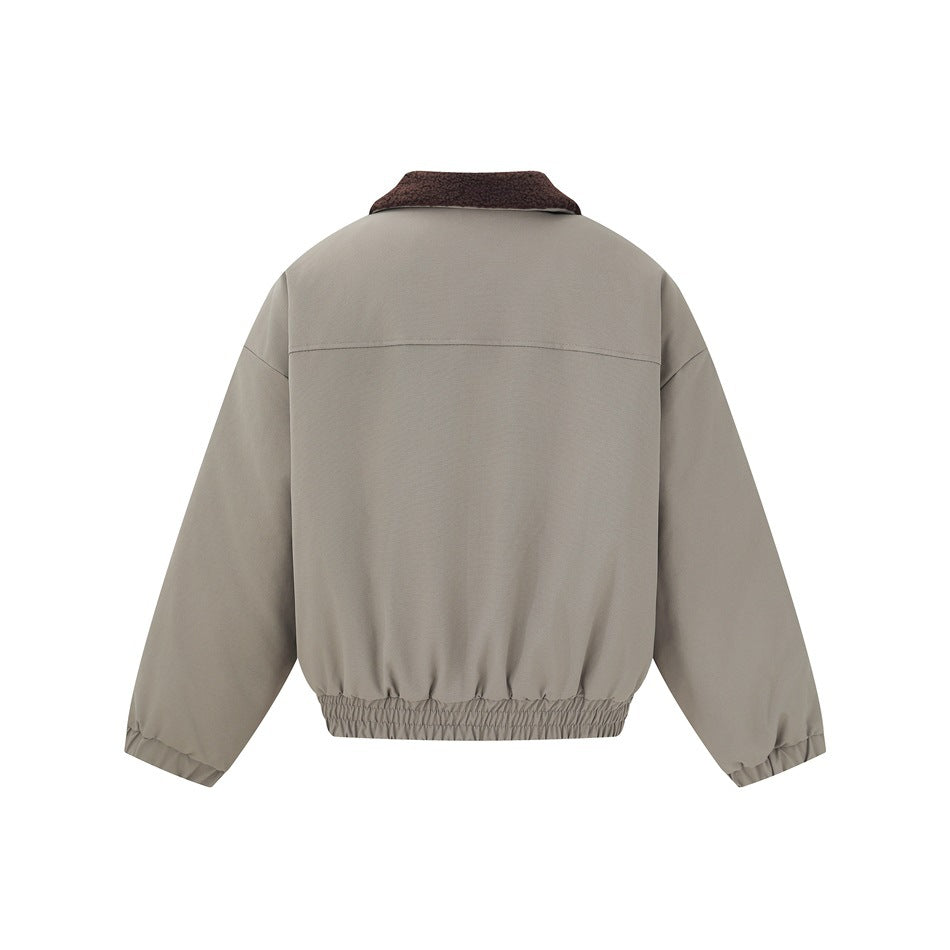 Back view of a taupe jacket with a dark brown collar, a horizontal yoke seam, and an elasticized hem.