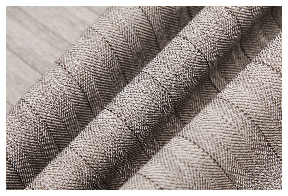 Macro view of the beige-gray striped fabric folded to show its woven texture.