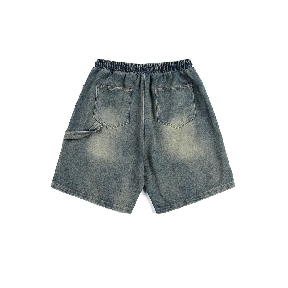 Back view of faded blue denim shorts with two patch pockets, elastic waistband and side utility loop