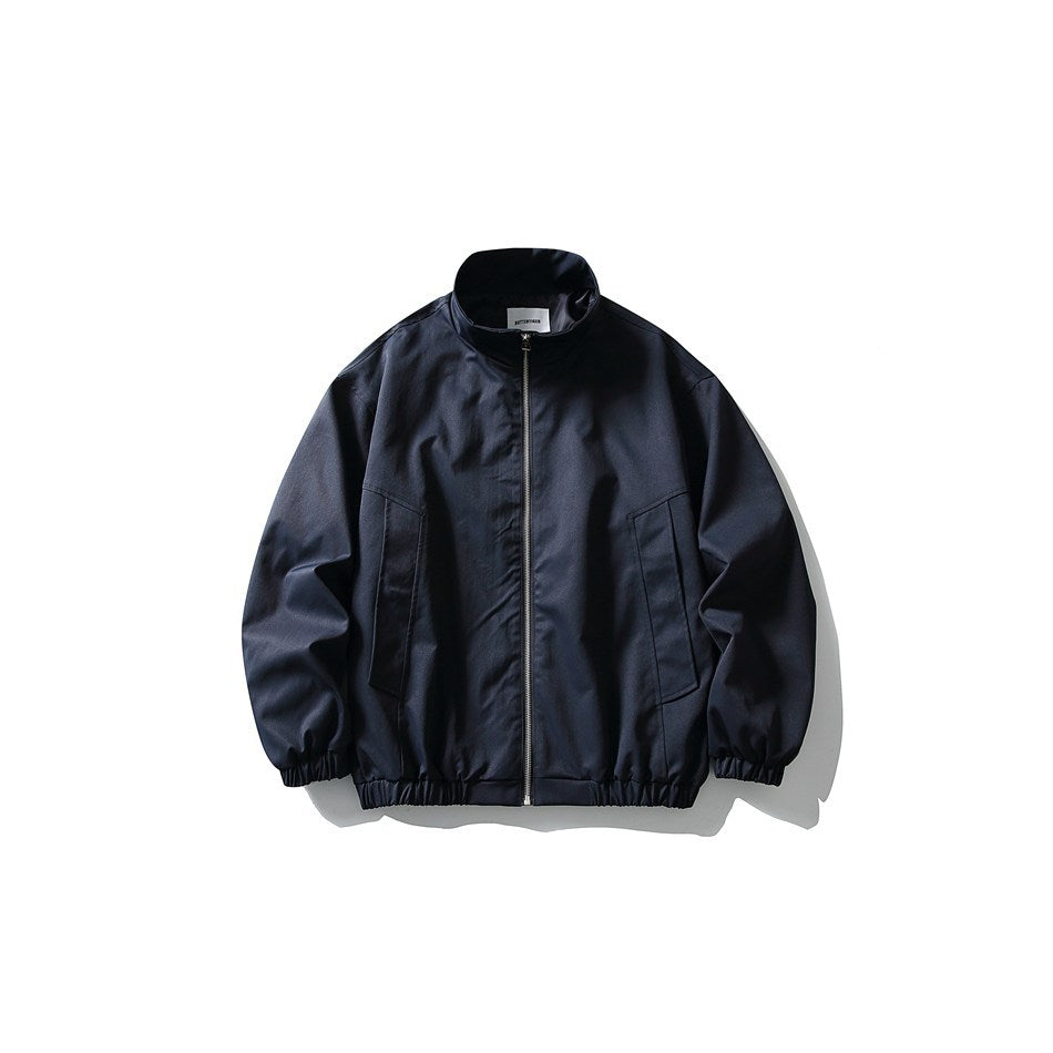 Navy blue stand-collar zip jacket with angled front pockets and elastic cuffs and hem, flat front view