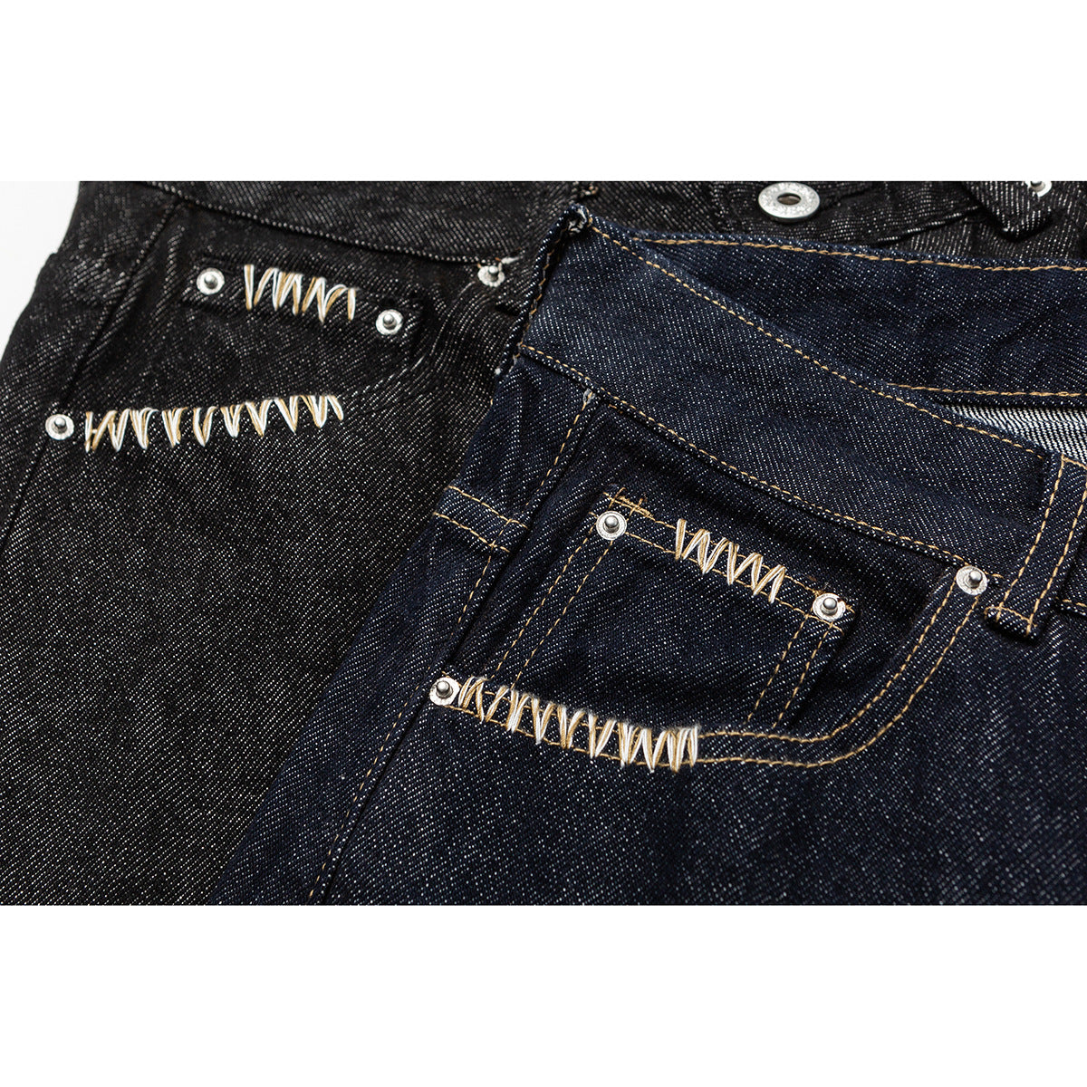 Close-up of dark denim with decorative cream stitching and silver rivets around buttonholes.