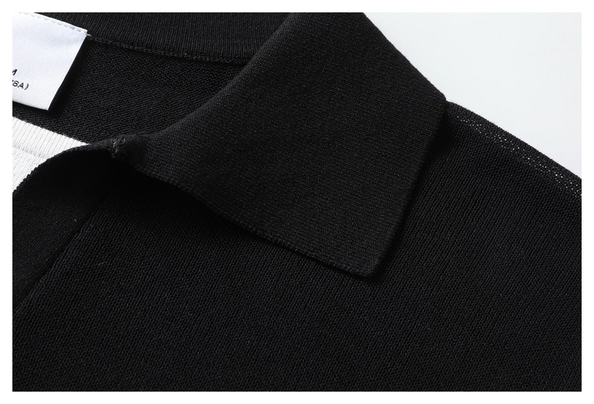 Close-up of the black knit polo collar and shoulder, showing the knit texture and a white inner panel.