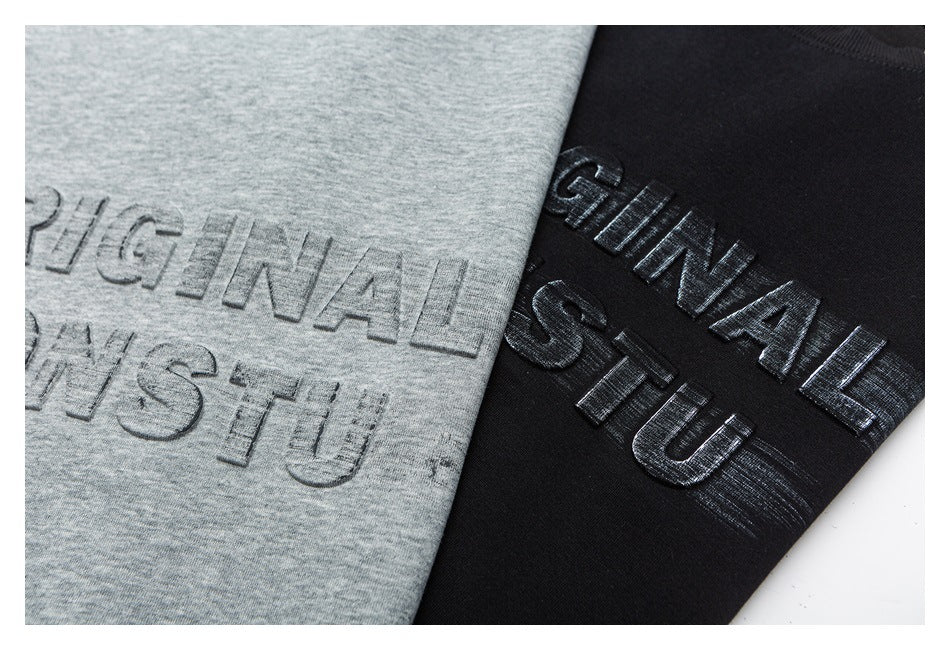 Close-up of raised lettering on gray and black sweatshirt fronts.