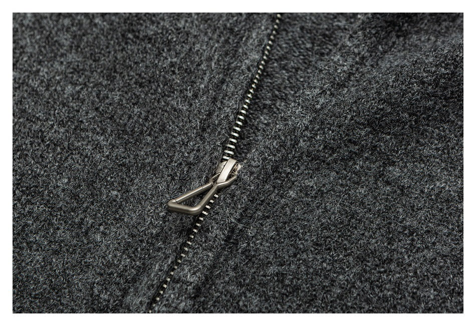 Close-up of the charcoal sweater's metal zipper and textured knit.