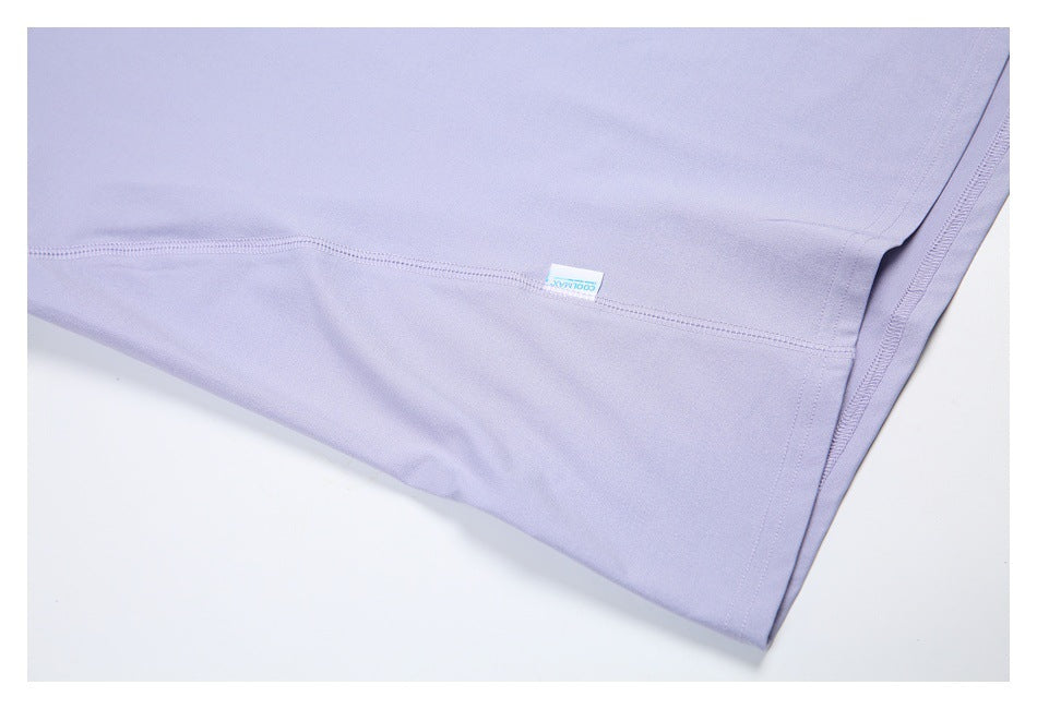 Close-up of a lavender garment panel with stitched seams and a small COOLMAX label.