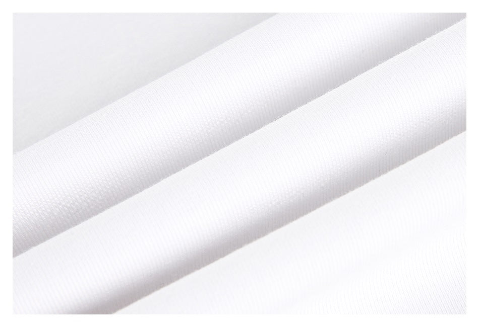 Macro view of white fabric folded to show its fine ribbed surface.