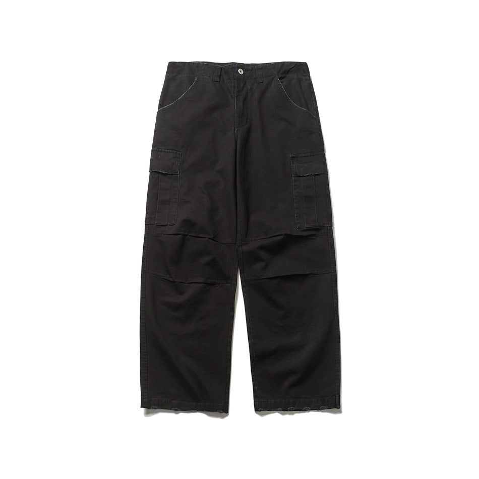 Black wide-leg cargo pants flat lay, front view, with thigh flap pockets, knee panels and frayed hems