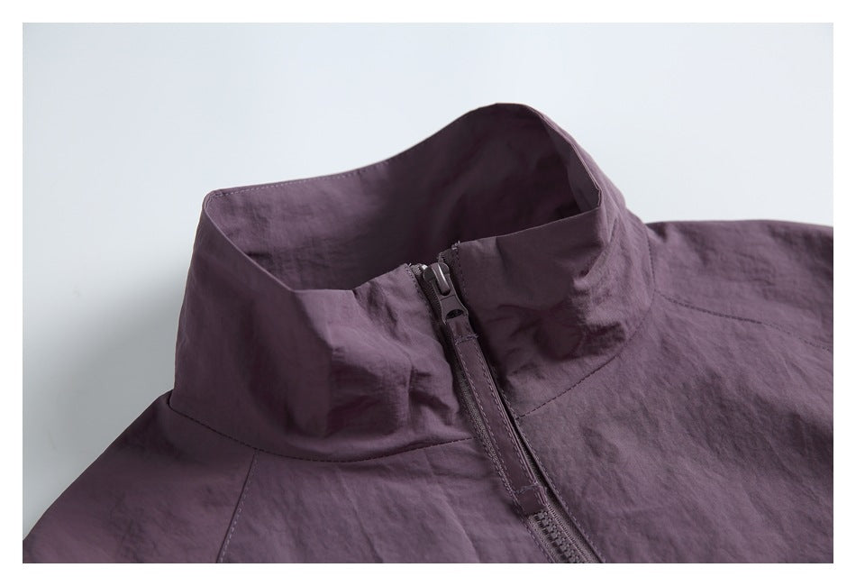 Close-up of a plum jacket's tall collar and front zipper.