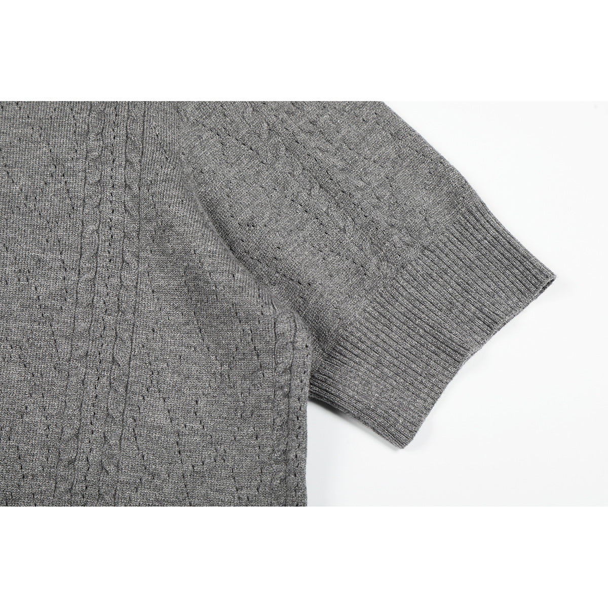 Close-up of a gray knit top’s short sleeve and ribbed cuff.