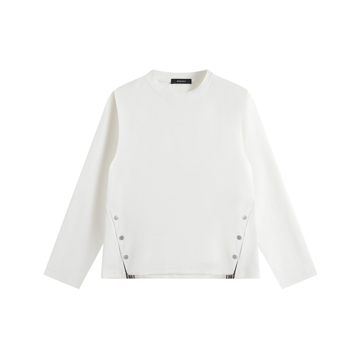 White long-sleeve crew-neck top, flat front view, with snap buttons at both sides and plaid trim at the hem corners
