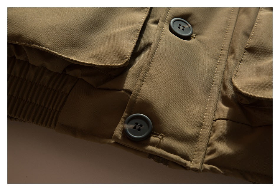 Close-up of tan-brown garment pockets, dark buttons, and a gathered elastic waistband.