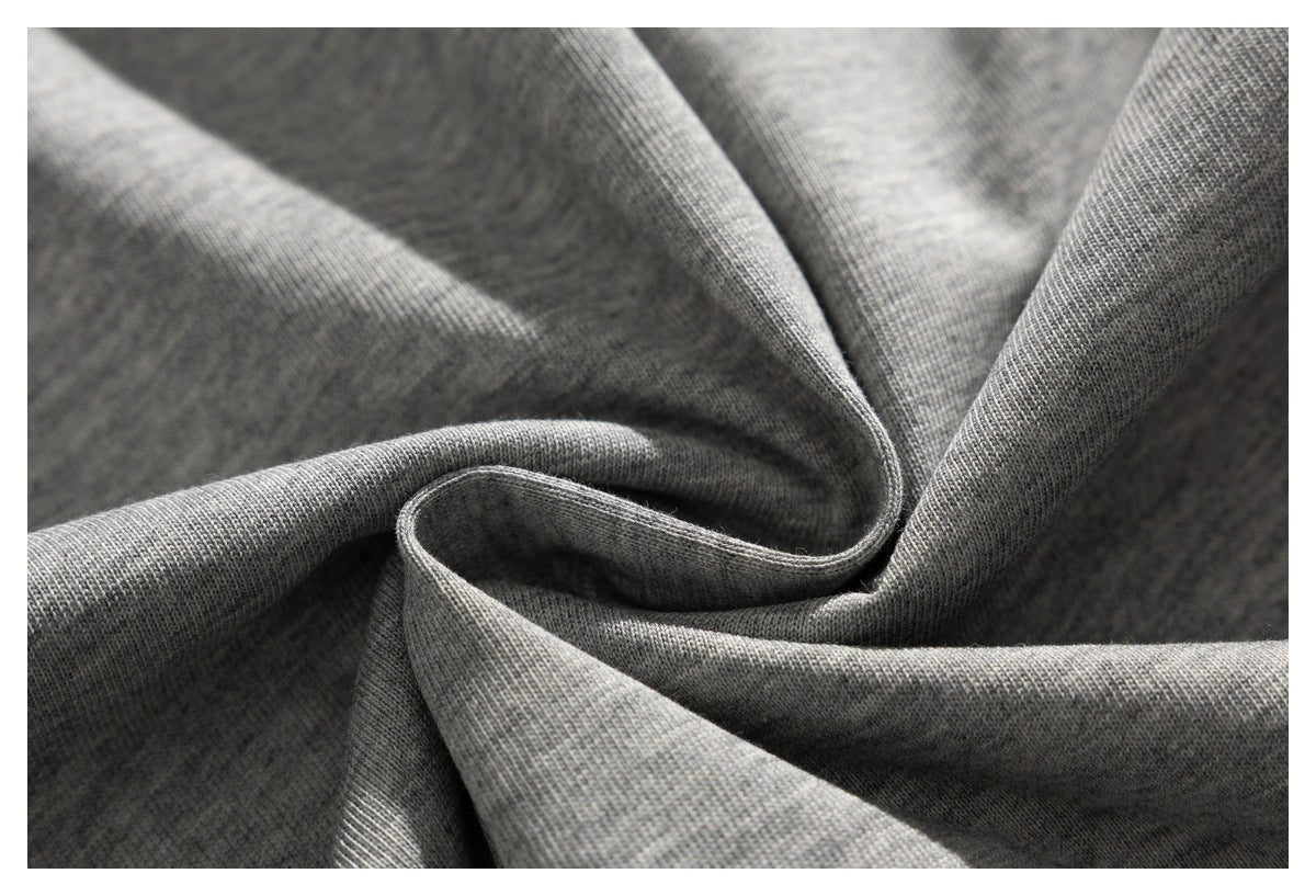 Close-up of heather gray knit fabric gathered into folds, showing its fine texture.