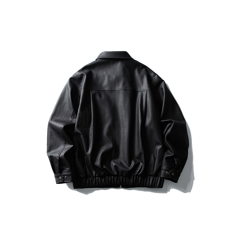 Back view of black faux-leather-look jacket with yoke seam, elastic hem and snap-button cuffs, flat lay