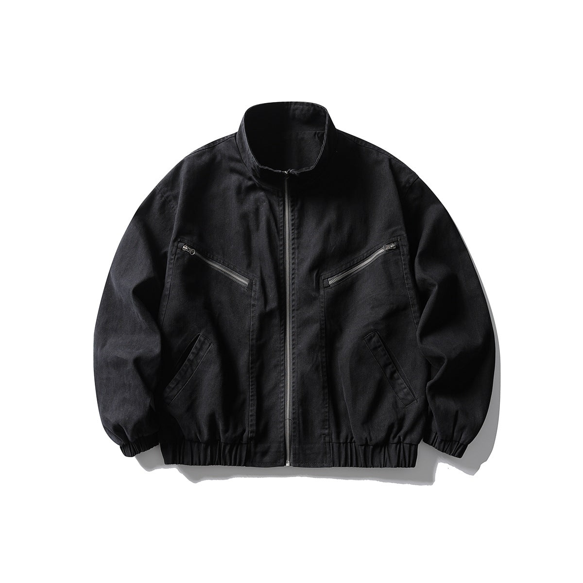 Black stand-collar zip jacket with zippered chest pockets and elastic cuffs and hem, flat lay front view