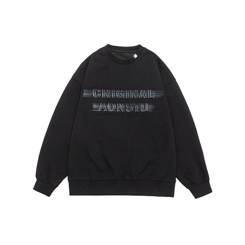 Black crewneck sweatshirt flat lay with metallic-look CRIGINAL AONSTU chest lettering and ribbed trim