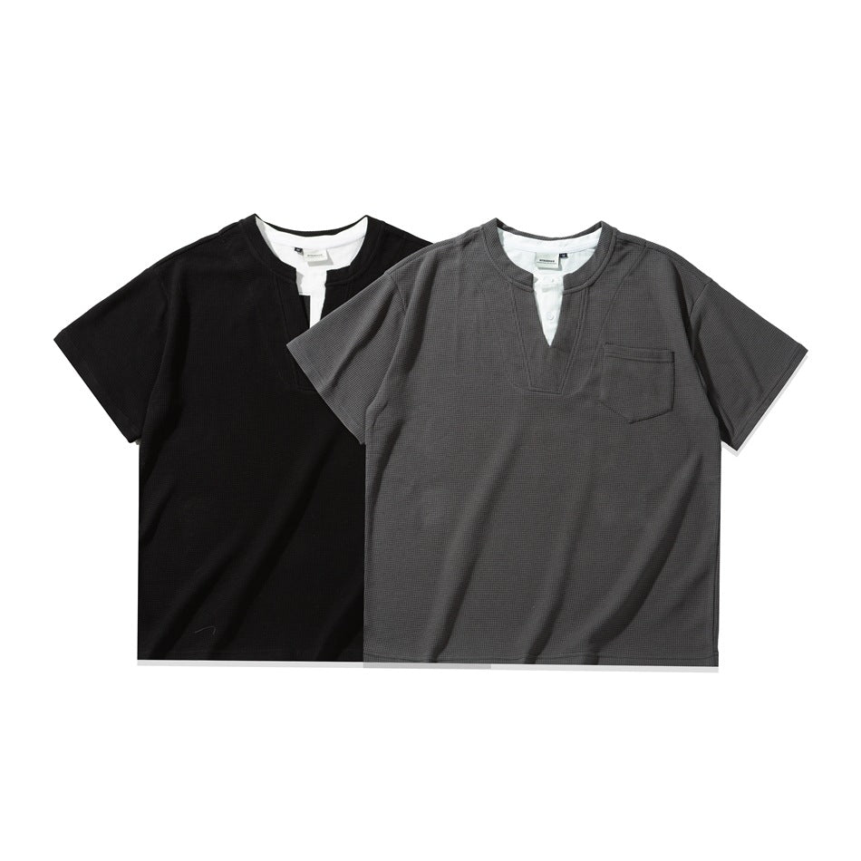 Two short-sleeve split-neck shirts shown side by side in black and charcoal gray, each with white trim and a chest pocket.
