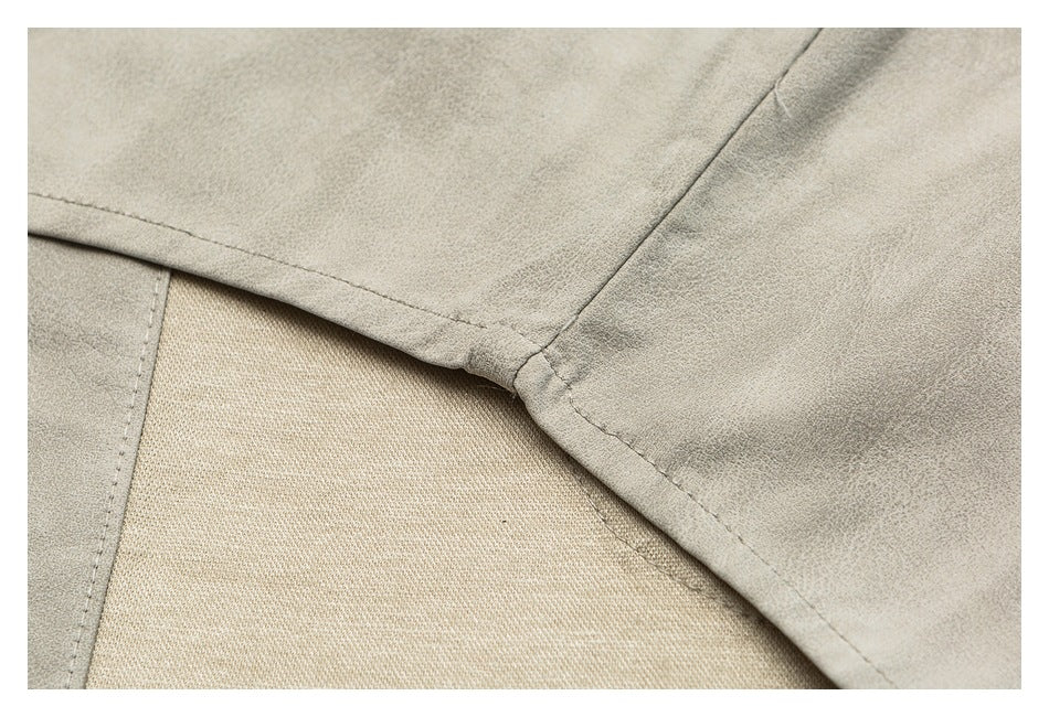 Close-up of light beige garment panels meeting at a stitched seam.