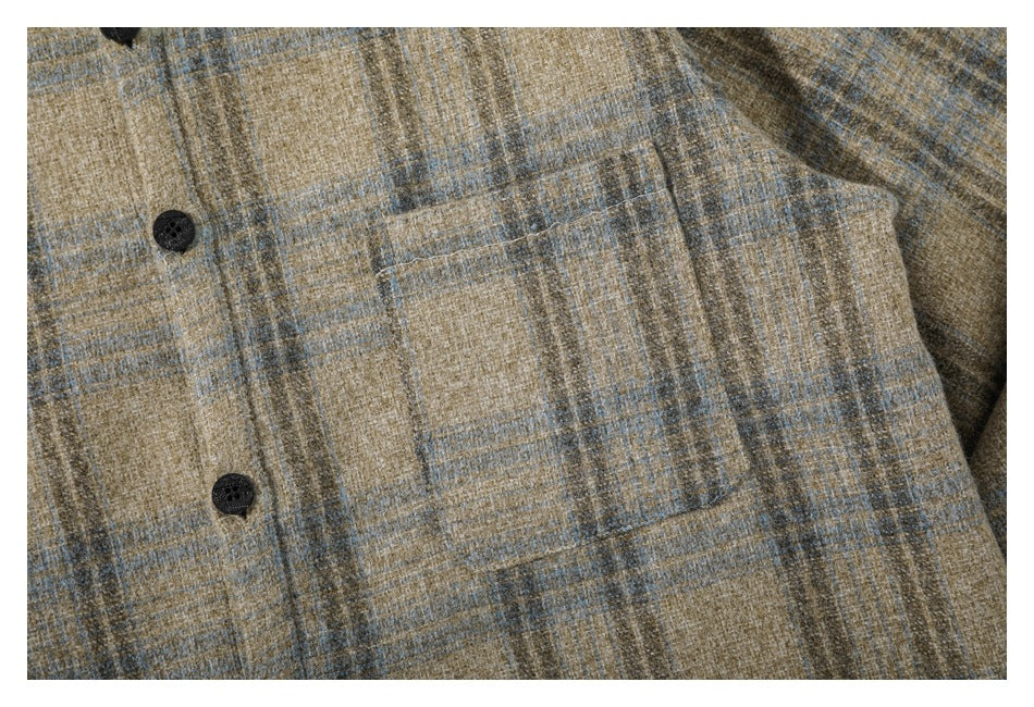 Close-up of the tan and gray plaid shirt showing a front button and a single chest pocket.