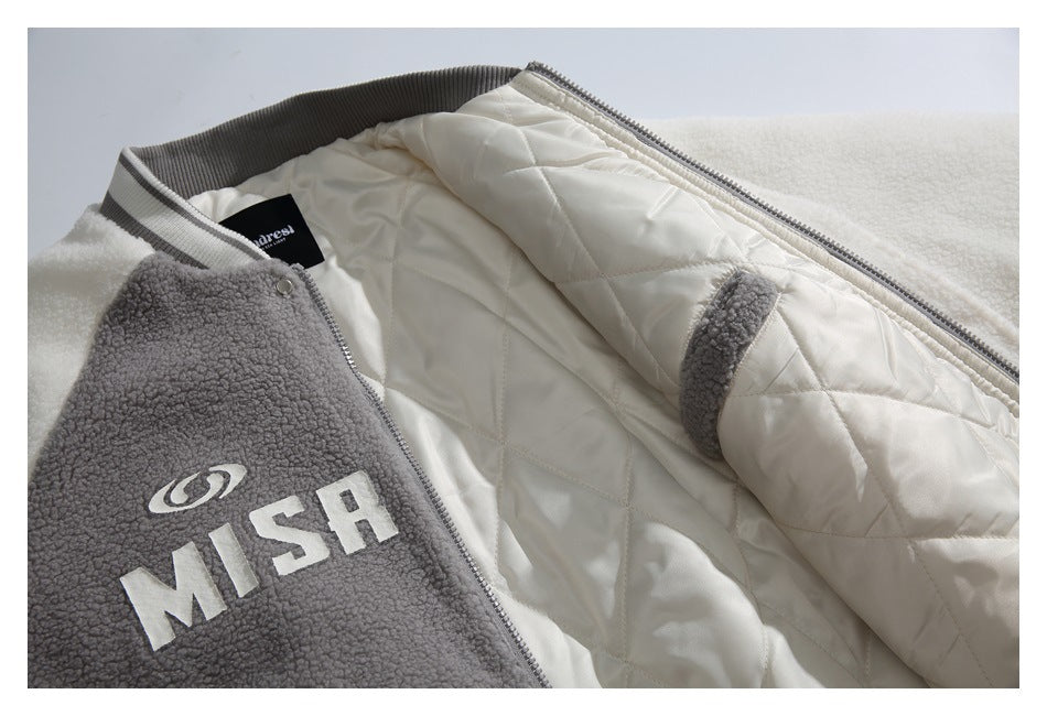 Open gray fuzzy jacket with cream quilted lining and large white MISH lettering on the front.