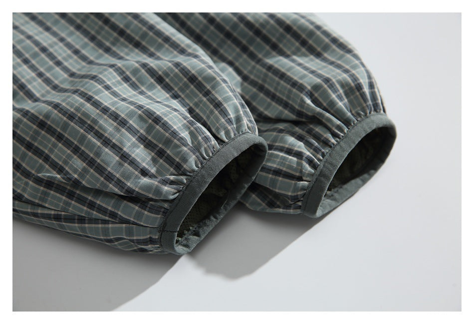 Close-up of gathered plaid jacket cuffs with dark edging.
