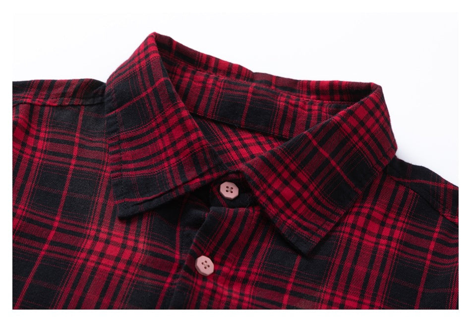 Close-up of a red-and-black plaid shirt collar and front with two pale pink buttons.