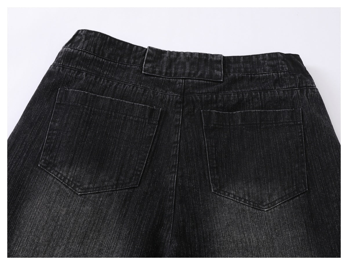 Rear view of black jeans showing the waistband, center seam, and two angular back pockets.