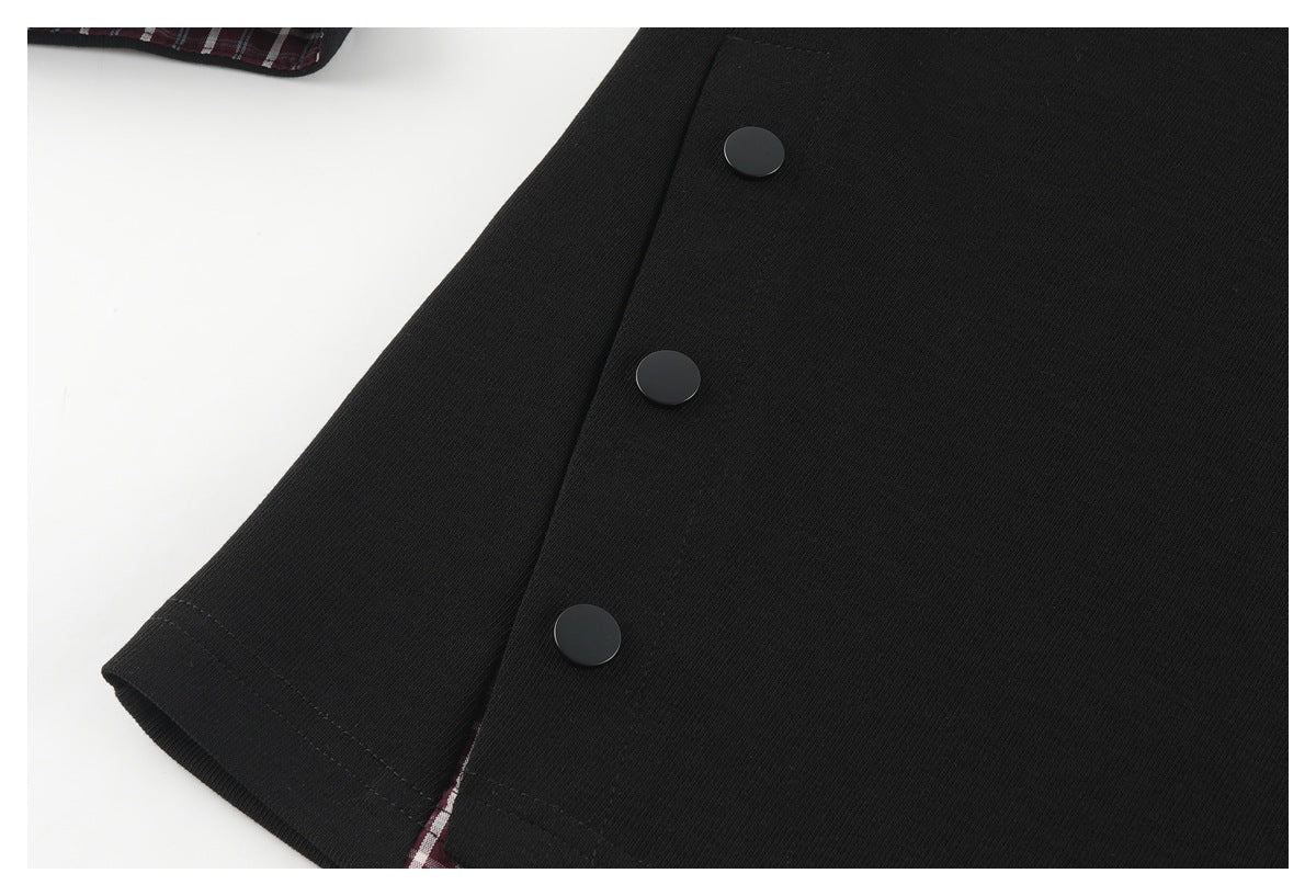 Close-up of a black sleeve and side panel with three dark snap buttons.