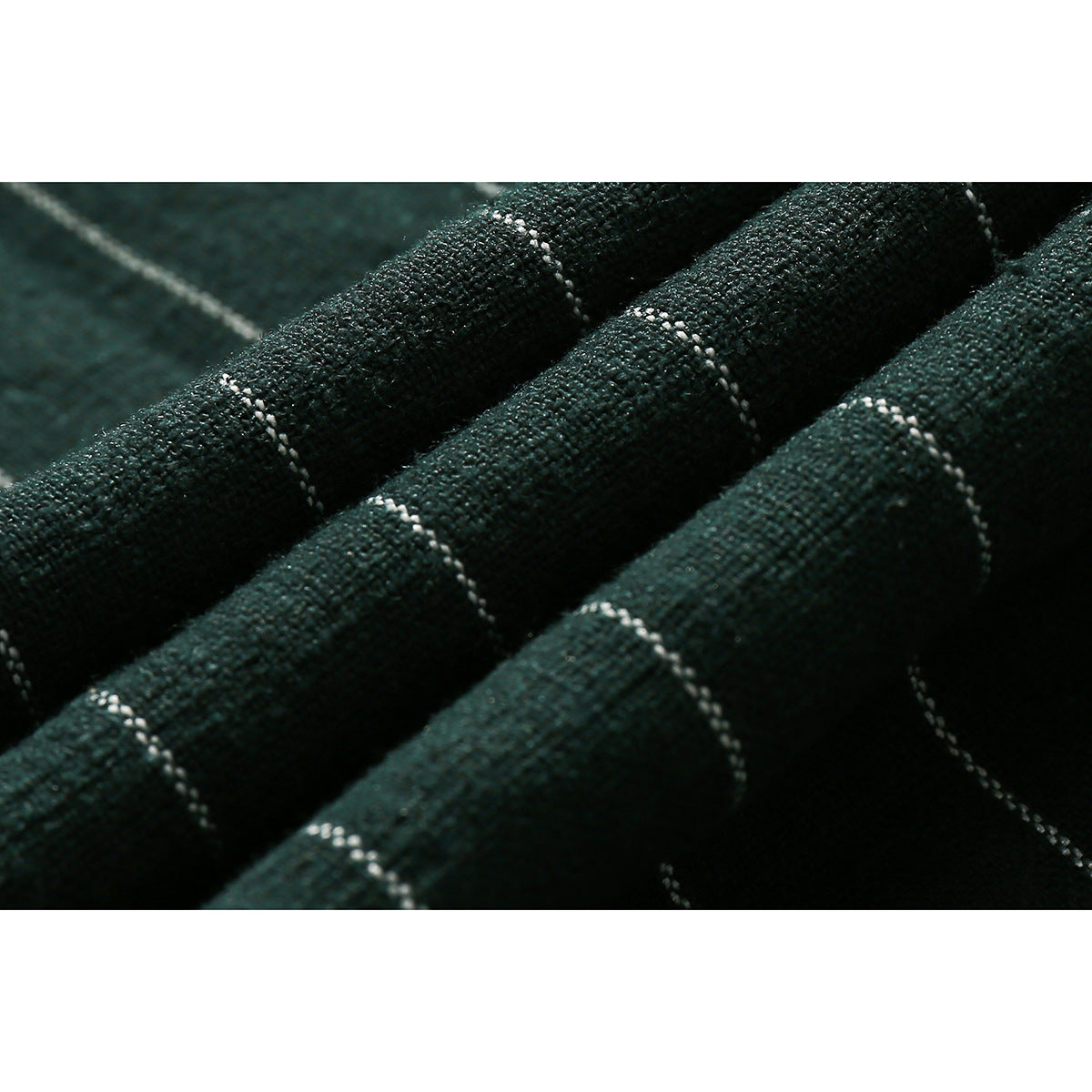 Macro view of dark green shirt fabric with fine white pinstripes and a textured weave.