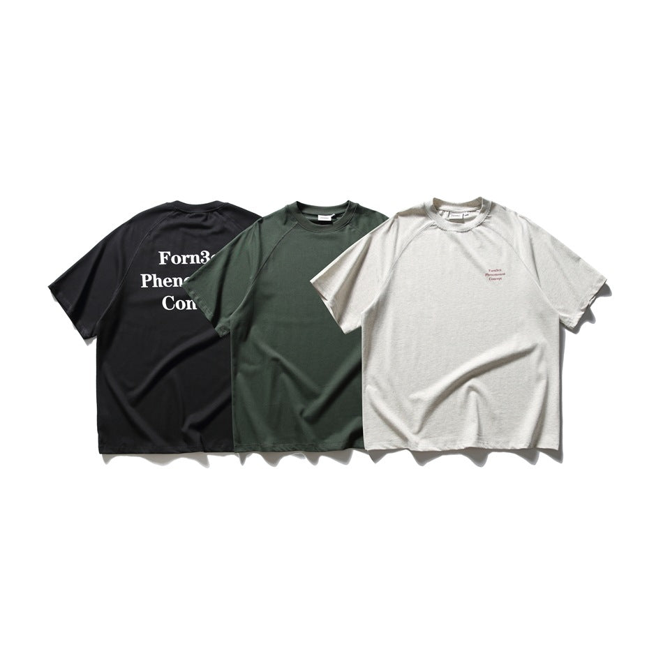 Three T-shirts shown together in black, dark green, and off-white colorways.