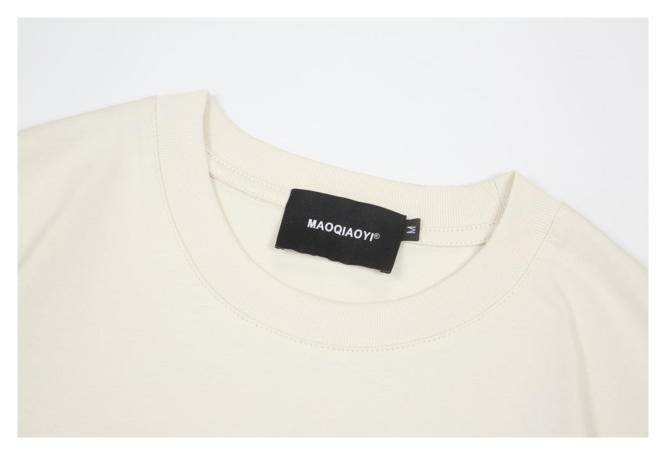 Close-up of the ivory sweatshirt ribbed crew neck and sewn-in brand and size labels.