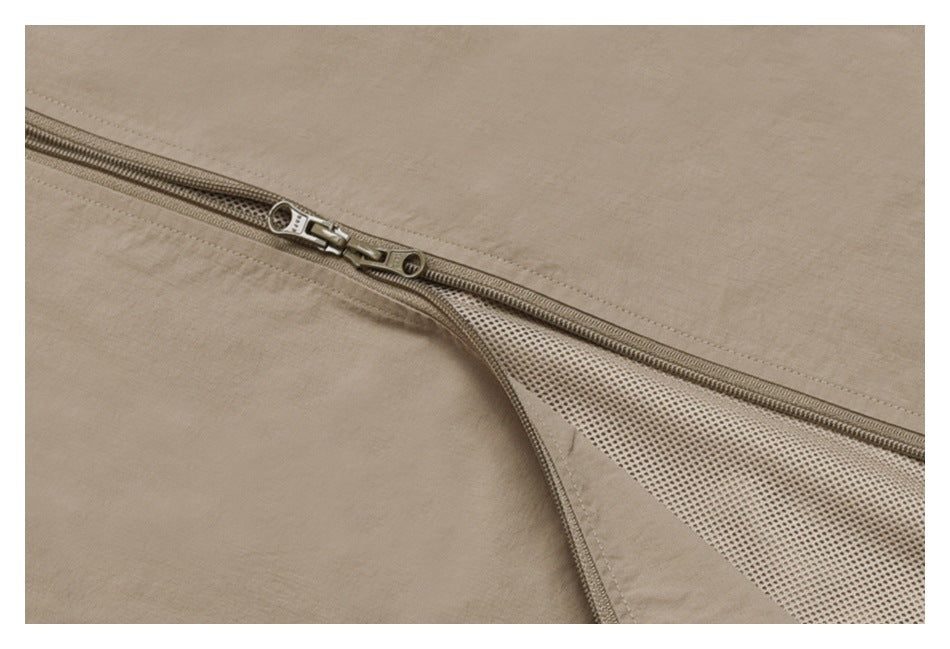 Close-up of a beige jacket's front zipper partly open to reveal mesh lining.