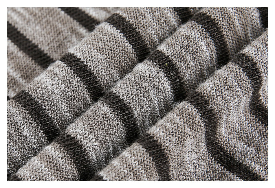 Close-up of gray and black striped knit fabric gathered into soft folds.