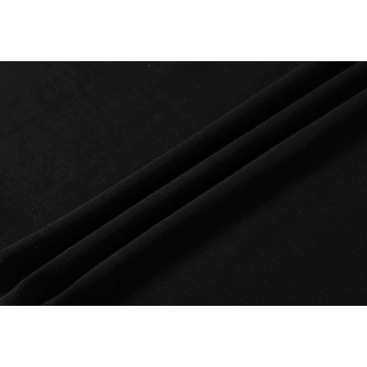 Close-up of black fabric arranged in diagonal folds, showing its surface texture.