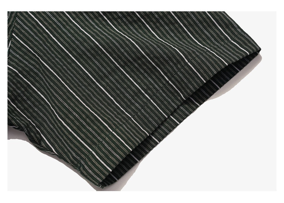Close-up of the dark striped shirt sleeve edge and stitched hem.
