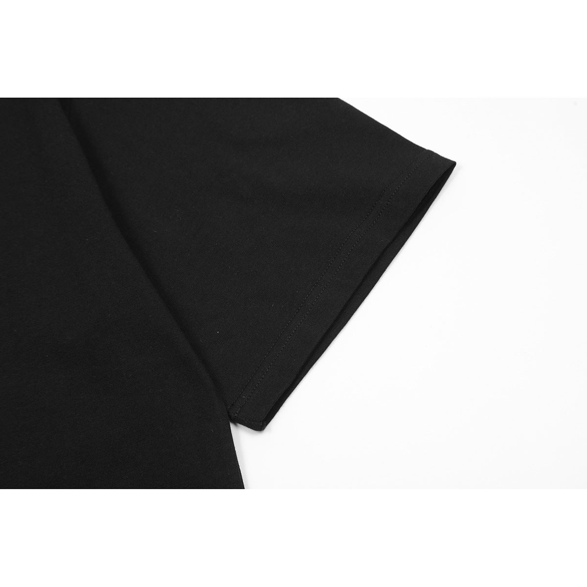 Close-up of a black T-shirt short sleeve and stitched cuff.