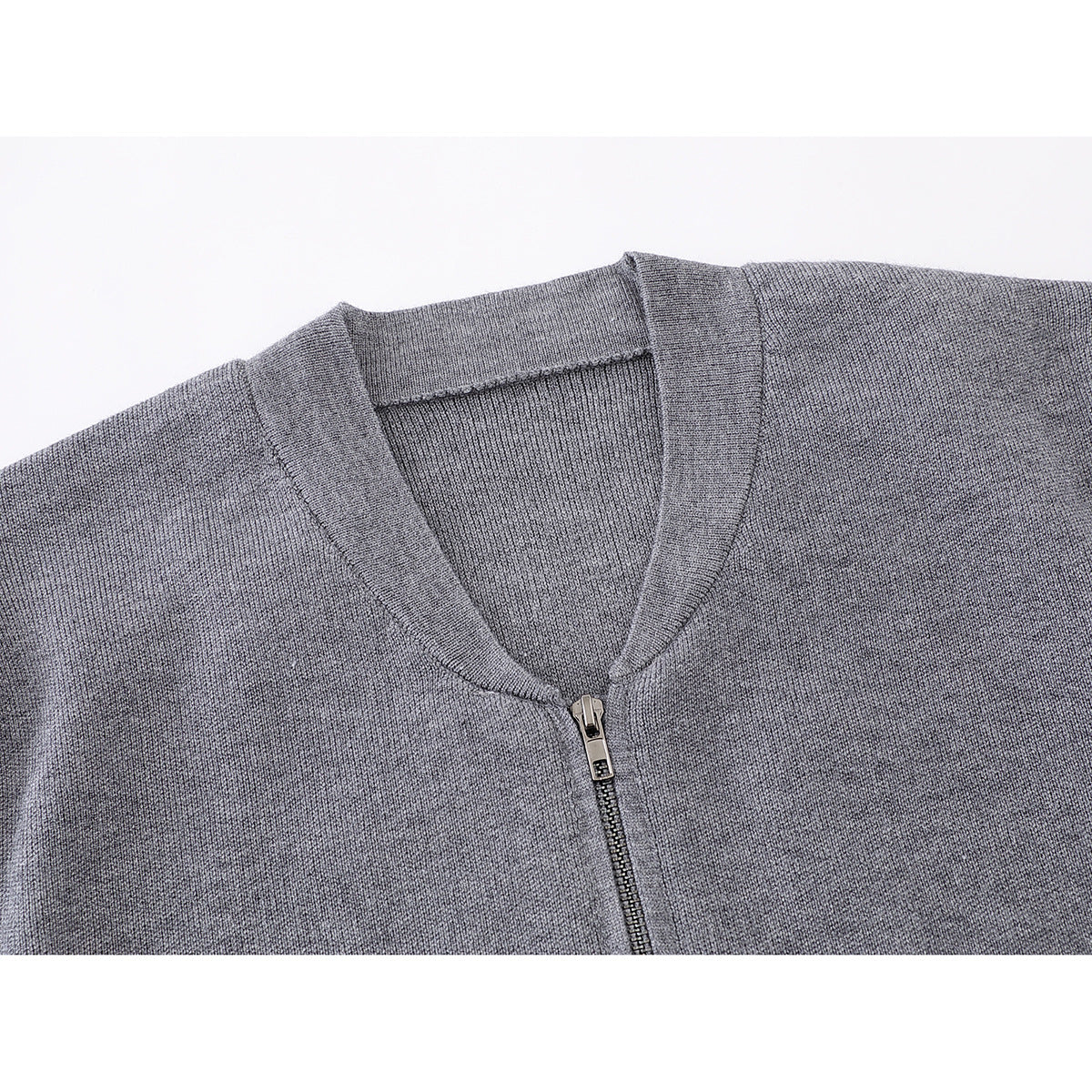Close-up of a gray knit zip-up jacket's V-neck collar and front zipper.
