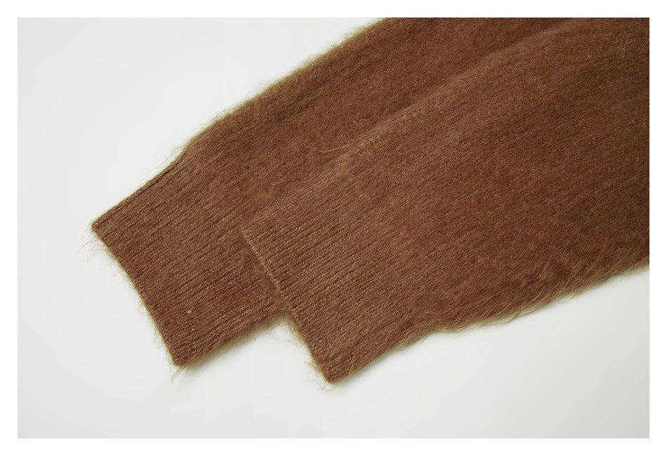 Close-up of a brown sweater sleeve ending in a ribbed cuff.