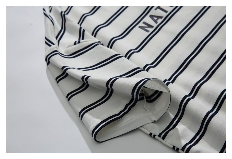Close-up of the striped sleeve and cuff on the ivory shirt.