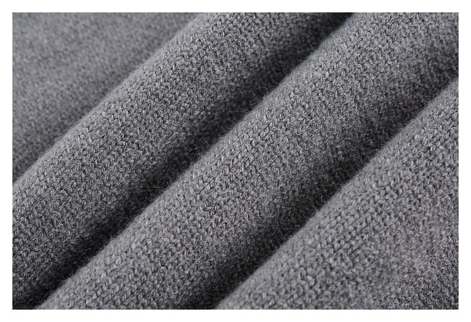 Macro view of gray knitted fabric folded into soft ridges.