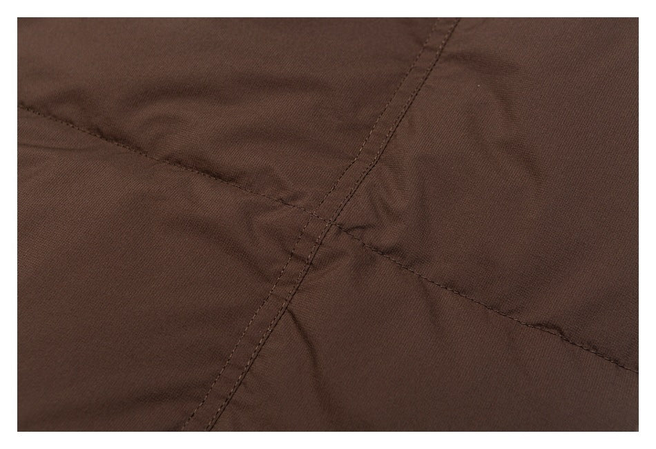 Close-up of brown jacket fabric with intersecting stitched seams.