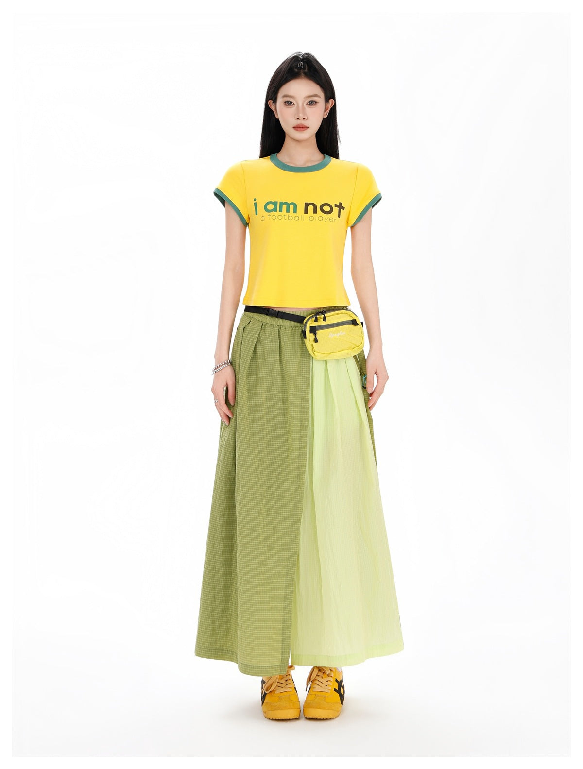 Full-length front view of a model in a yellow green-trim T-shirt and olive and pale-chartreuse color-block maxi skirt.